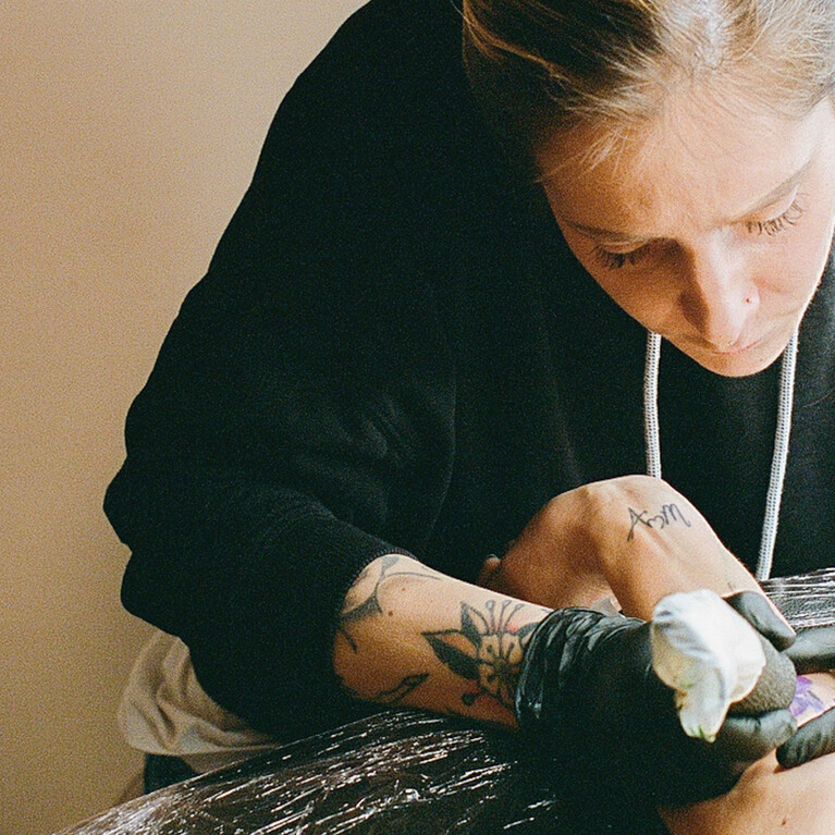 Eva Edelstein designing a tattoo